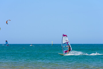 Vieste, Italy. In the sea of Vieste, near the Scialmarino beach, some people practice windsurfing and others practice kitesurfing. September 7, 2022