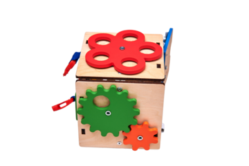 Busyboard cube for infant baby on the nursery floor, isolated on a white background. Educational toys for children, wooden gamepanel
