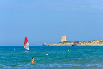 Vieste, Italy. Windsurfer near the Scialmarino beach. The trabucco of Tufara Bay and the Porticello...