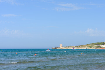 Vieste, Italy. From the Scialmarino beach the trabucco of the Tufara Bay and the Porticello Tower. Summer day along the coast of Vieste. September 7, 2022