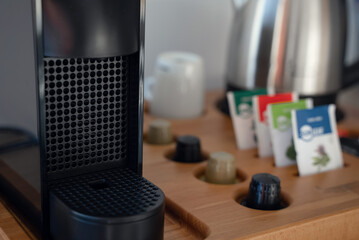 Group of coffee making set in a hotel room with stainless steel electric kettle, clean cup, teaspoon