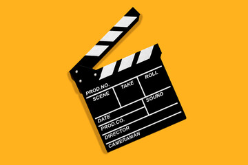 Fototapeta na wymiar Clapperboard for shooting video footage takes on a orange background