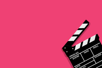 Movie clapperboard for shooting videos and movies on a pink background plenty of space for text
