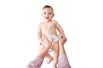 A mother woman puts on a diaper for a baby boy, isolated on a white background. Mom dresses a happy...