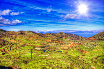 North-west coast of Tenerife mountains and green grass with blue sky with clouds, Canarian Islands