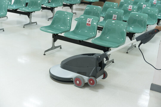 Woman Maid Cleaning Floor With Machine Cleaner In The Business Office.Big Cleaning Day.Floor Care With Machine In Hospital.