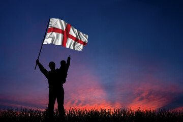 Father and son hold the flag of England