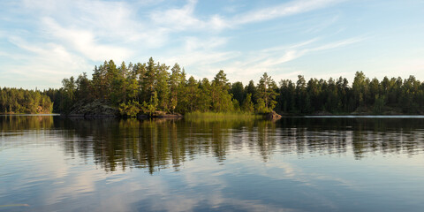 forest lake with rocky island and reflection