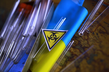 Ukrainian flag biohazard and test tubes. Assistance to Ukraine in biolaboratories. Western biological laboratories in Ukraine.