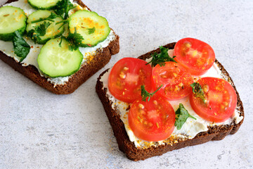 healthy sandwiches with ricotta, tomato and cucumber slices and curcuma, close-up