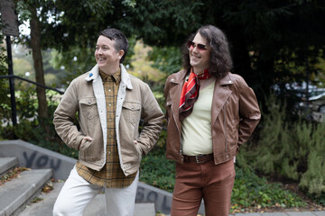 Fototapeta premium lifestyle image of transgender nonbinary friends talking in the park
