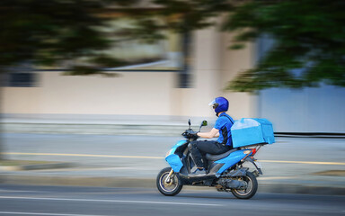 Food delivery moto scooter driver is on his way to deliver food. Courier on motor scooter...