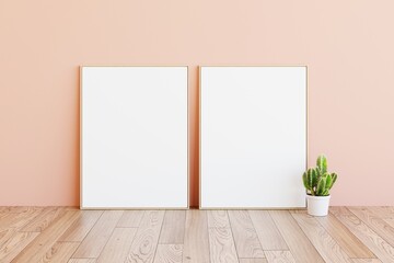 Two artwork sample frames display in bright creamy pink modern room background with cactus plant on wooden floor. Frames lean to pink wall background. 3D rendering. 3d illustration © Washdog