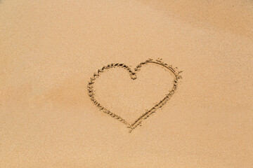 Fototapeta na wymiar Heart symbol written in a sand