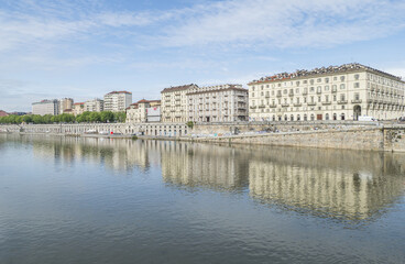 The murazzi of Turin with the palaces that are reflected in the water of the river Po