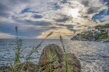 Paysage en bord de mer juste avant le coucher de soleil sur la Côte d'Azur avec des rochers et des...