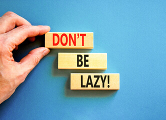 Motivational and do not be lazy symbol. Concept words Do not be lazy on wooden blocks on a beautiful blue table blue background. Businessman hand. Business do not be lazy concept. Copy space.