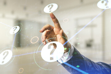 Man hand presses on abstract virtual question mark illustration on blurred office background. FAQ...
