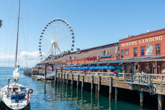 Scenic view of the Seattle pier at water with Ferris wheel in the background