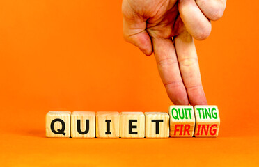Quiet quitting or firing symbol. Concept words Quiet quitting Quiet firing on cubes. Businessman...