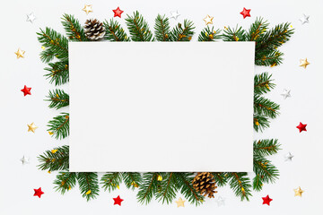 Christmas, New Year holiday layout with copy space for text. Blank white paper in frame of natural fir tree branches, pinecones and decorations on white flat lay background.