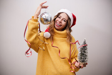 Woman in a New Year's hat with a disco ball and a Christmas tree