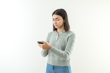 Fototapeta premium Confused and angry young girl with short hair looking at phone.