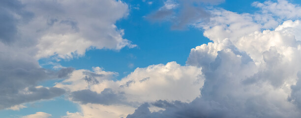 Dramatic blue sky with white and gray clouds in sunny weather