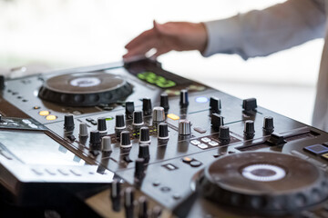 Dj mixer hand at a party playing rock pop regueton music