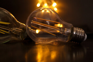 Lightbulb with candles in the background. Concept of loadshedding, power cuts or blackouts....