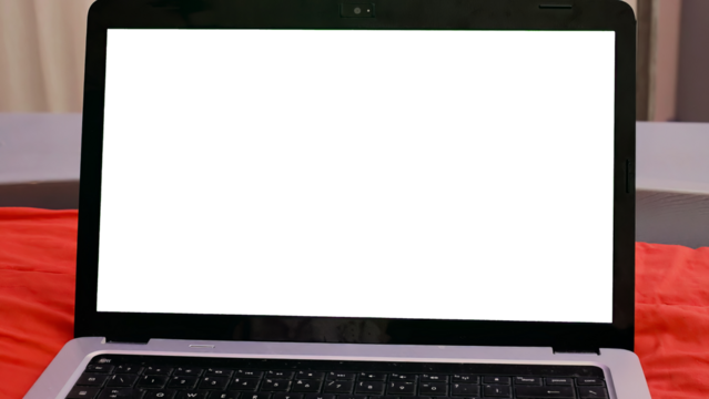 A laptop on a bed showing a blank cutout screen.
