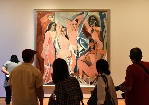 New York, USA - May 25, 2018: Crowd of people near the Pablo Picasso painting "Les Demoiselles D'Avignon" in Museum of Modern Art in New York City.