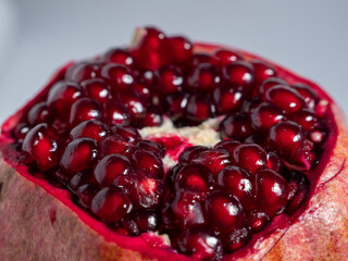 Ripe pomegranate. Fresh juicy pomegranate on a light background.