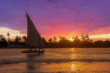 A felucca sailing on the River Nile at Aswan - obrazy, fototapety, plakaty