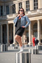 Young woman on ctiy trip in Paris France posing at the Palais Royal.