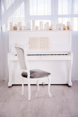 Vintage white musical instrument piano with white candles