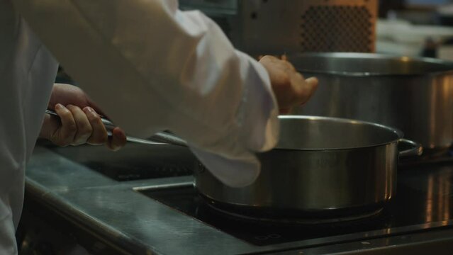 The cook uses a gas cylinder and creates a flame.