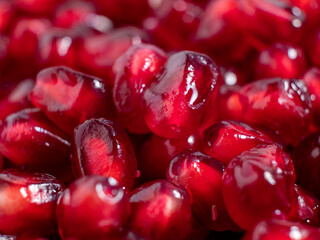 Ripe pomegranate. Fresh juicy pomegranate seeds on a light background.