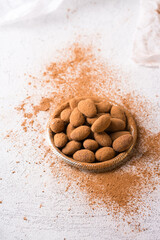 Roasted Almond nuts in chocolate sprinkled with carob powder