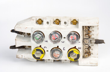 Closeup of an old ceramic fuse box with fuses