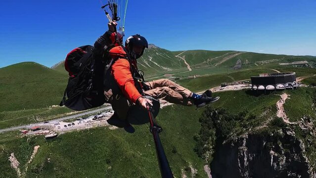 tandem paragliding in sunny weather, in mountainous terrain, sports, extreme