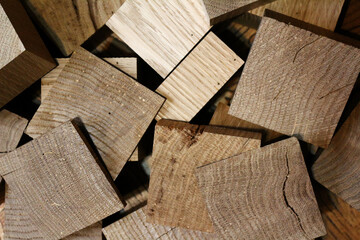sanded oak wooden squares randomly piled in a pile - close-up top view