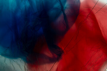 transparent cellophane colored bags close-up background texture of plastic