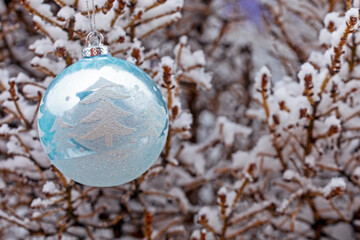 blue christmas ball on christmas snow covered tree. christmas background. decor, festive background,