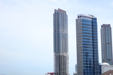 Fototapeta na wymiar Background photo of two tall blue buildings