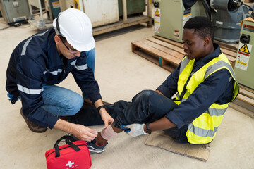 Male assistant first aid male worker accident with broken leg in the factory. Health insurance concept