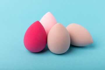 Beauty blender. Cosmetic sponge on a blue background. MOCAP. Sponge for applying foundation and concealer. Beauty concept. Space for text. Space for copy space.