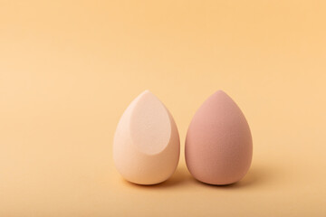 Beauty blender. Cosmetic sponge on a beige background. MOCAP. Sponge for applying foundation and concealer. Beauty concept. Space for text. Space for copy space.