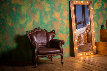 Antique armchair and mirror with light bulbs