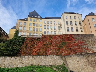 View of old city wall of Luxembourg with red autumn leaf